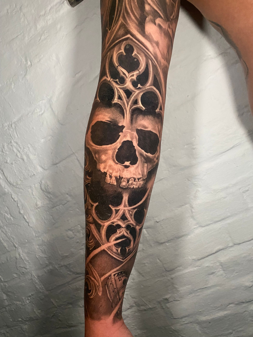 Gothic skull sleeve in black and grey realism